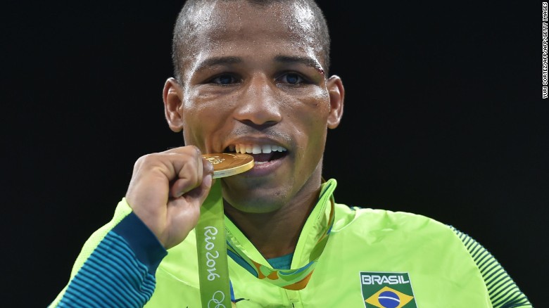 Brazil&#39;s Robson Conceicao poses with a gold medal at the Rio 2016 Olympic Games in Rio de Janeiro on August 16, 2016. 
