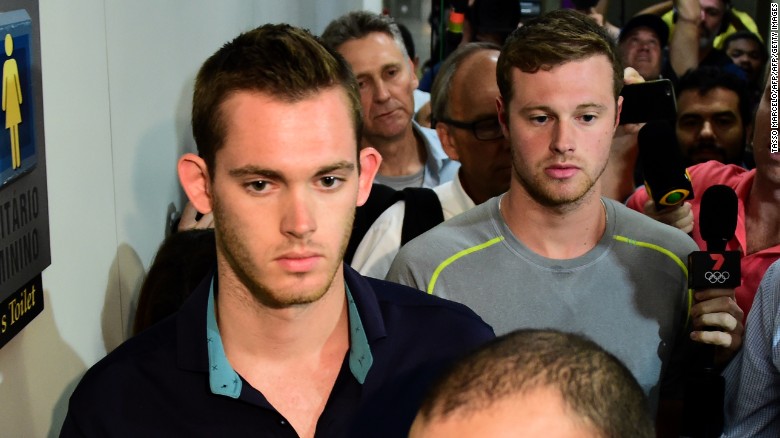 American swimmers Gunnar Bentz (L) and Jack Conger leave the police station at the Rio de Janeiro International Airport after being detained on the plane that would travel back to the US.  

Brazilian police arrested two US swimmers and a top International Olympic Committee official as scandal overshadowed the Rio Games and Usain Bolt's progress toward a new gold.  Jack Conger and Gunnar Bentz were taken off a flight leaving Rio de Janeiro by authorities investigating doubts over their claim to have been mugged. / AFP / TASSO MARCELO        (Photo credit should read TASSO MARCELO/AFP/Getty Images)