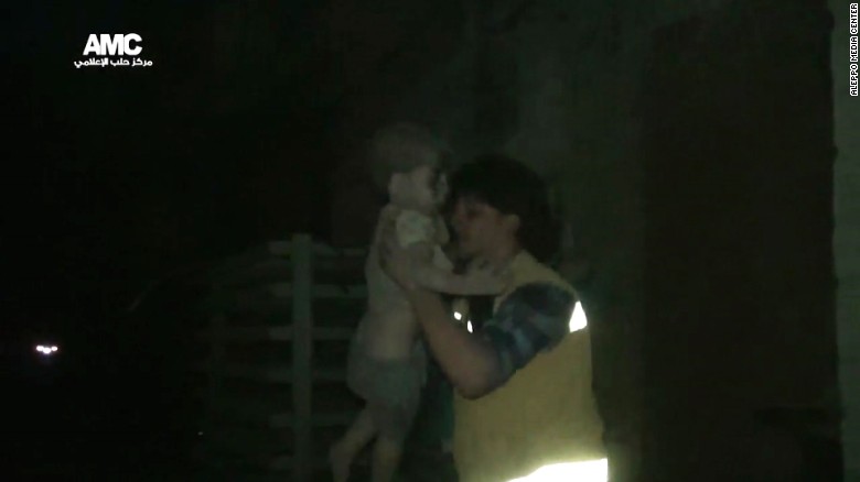 A civil defense worker carries Omran into the ambulance. The airstrike destroyed Omran&#39;s home, where he lived with his parents and two siblings. All survived.