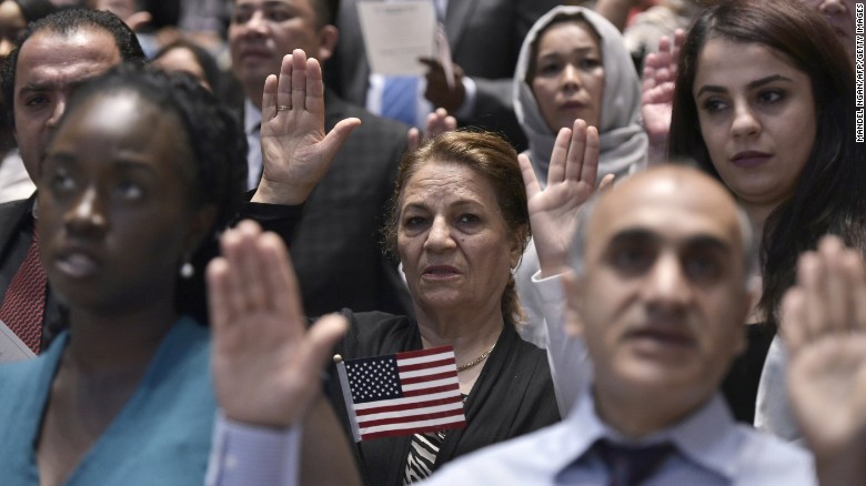 Citizenship candidates take the Oath of Allegiance to the US during a naturalization ceremony on World Refugee Day in recognition of those who have come to the US with refugee or asylum seeker status, at the US Holocaust Memorial Museum on June 20, 2016 in Washington, DC. 