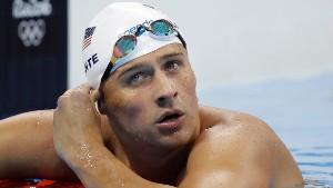 FILE - In this Tuesday, Aug. 9, 2016, file photo, United States&#39; Ryan Lochte checks his time in a men&#39;s 4x200-meter freestyle heat during the swimming competitions at the 2016 Summer Olympics, in Rio de Janeiro, Brazil. Lochte and three other American swimmers were robbed at gunpoint early Sunday, Aug. 14, by thieves posing as police officers who stopped their taxi and took their money and belongings, the U.S. Olympic Committee said. (AP Photo/Michael Sohn, File)