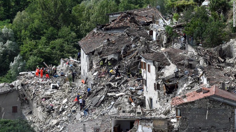 Search-and-rescue teams survey collapsed houses in Pescara del Tronto, Italy, on August 24.