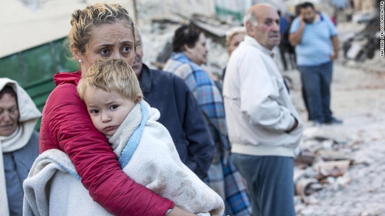 A woman tries to comfort her child in Amatrice on August 24.