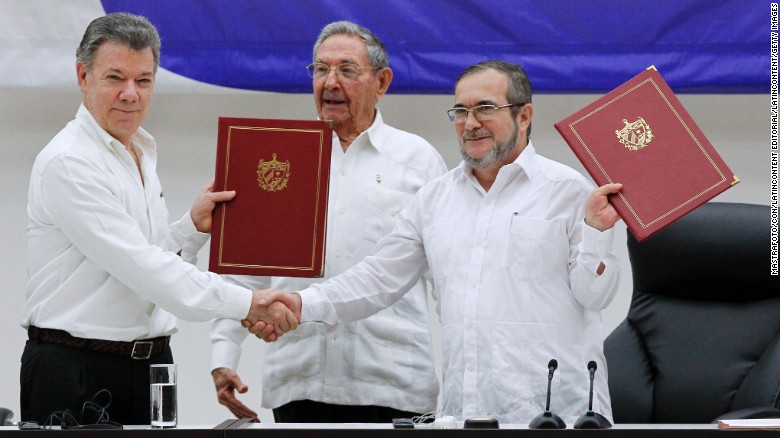 President Juan Manuel Santos, left, and FARC official Timoleon Jimenez mark a ceasefire in June. 