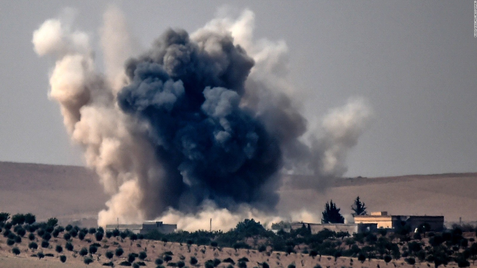 Smoke billows following air strikes by a Turkish Army jet fighter on the Syrian Turkish border village of Jarabulus.