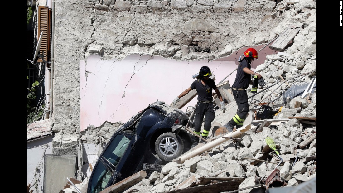 Rescuers make their way through destroyed houses in Pescara del Tronto on Thursday, August 25. It&#39;s unclear how many people remain trapped under debris.