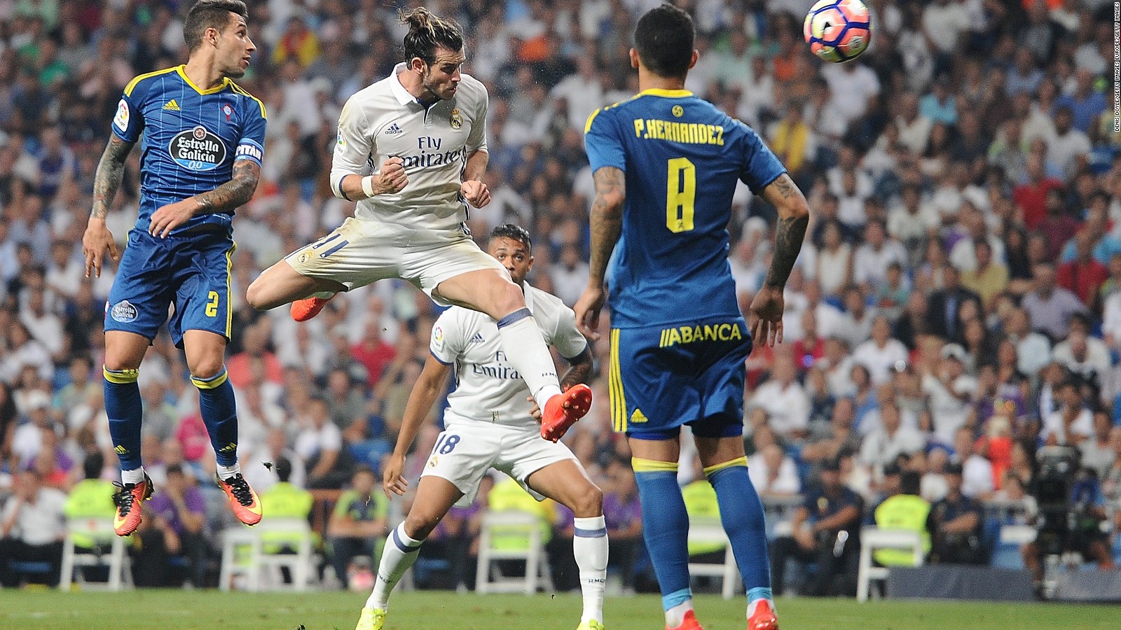 Real Madrid's Gareth Bale heads past Pablo Hernandez of Celta Vigo.