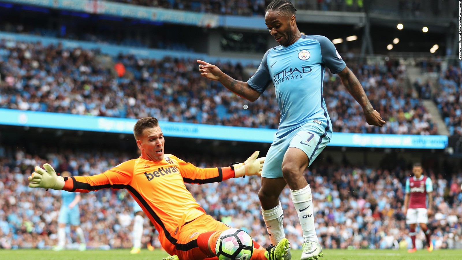 Manchester City's Raheem Sterling rounds goalkeeper Adrian of West Ham United to score his second goal.