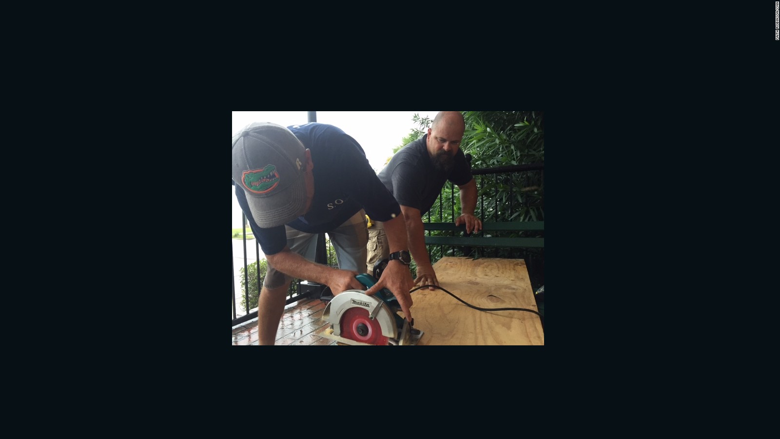 Joshua Wolfhagen, left, and Lake Smith cut a board for a window at The Consulate hotel in Apalachicola on Thursday,