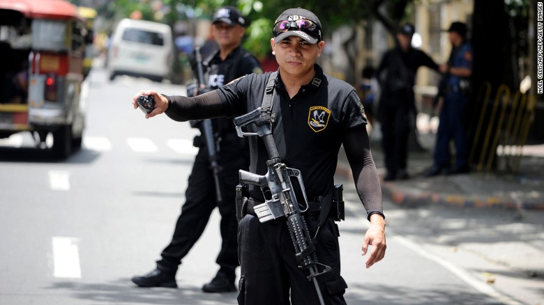 SWAT team members patrol the streets of Manila in the wake of the Davao City bombing.