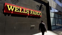 A man passes by a Wells Fargo bank office in Oakland, California. Regulators announced Thursday, September 8 that Wells Fargo is being fined $185 million for illegally opening millions of unauthorized accounts for their customers in order to meet aggressive sales goals. 