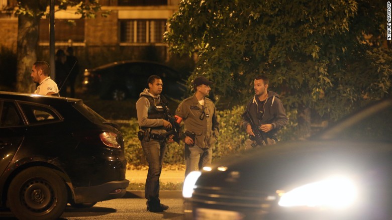 Police officers stand guard as they take part in a raid in Boussy-Saint-Antoine, September 8, 2016.