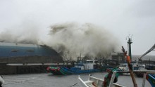 Huge waves wash over a ship in a fishing port in Taitung county, Taiwan. 