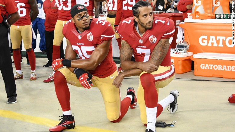 Colin Kaepernick (right) and Eric Reid of the San Francisco 49ers kneel in protest during the national anthem on September 12, 2016, in Santa Clara, California.  