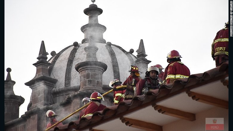 Firefighters check out damage to the roof of San Sebastian Church. The church&#39;s roof is in danger of collapsing.