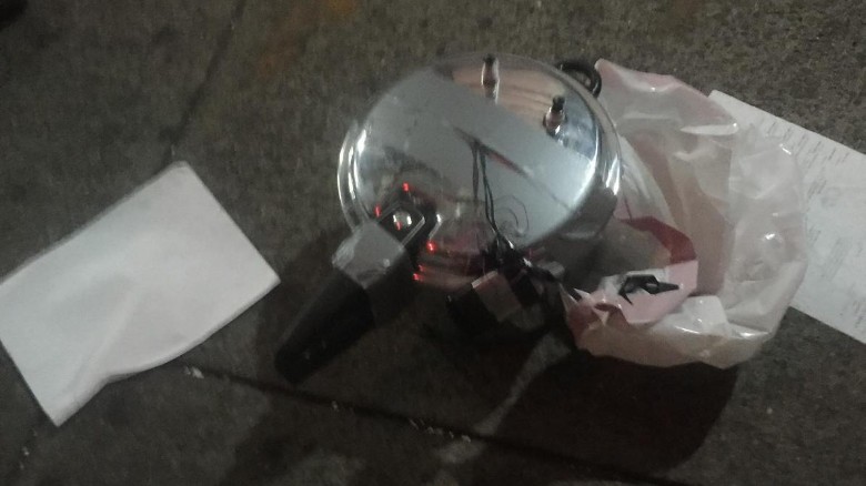 A suspicious device at a second location in Chelsea appears to be a pressure cooker with dark-colored wiring coming out of its top. 