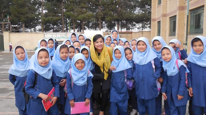 Najeeba Wazefadost with Afghan refugee students in Iran, where she helps with education expenses. 