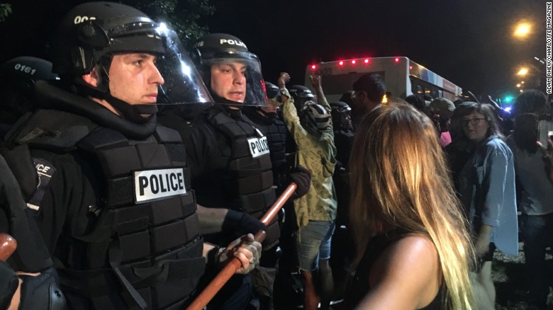 Protesters clash with police early Wednesday in Charlotte after an officer shot and killed a man.