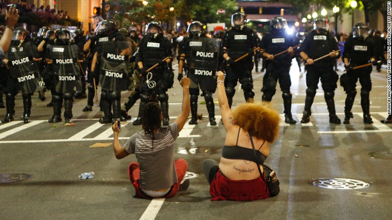 CHARLOTTE, NC - SEPTEMBER 21: Police clash with protestors as residents and activists protest the death of Keith Scott September 21, 2016 in Charlotte, North Carolina. Scott, who was black, was shot and killed at an apartment complex near UNC Charlotte by police officers, who say they warned Scott to drop a gun he was allegedly holding. (Photo by Brian Blanco/Getty Images)