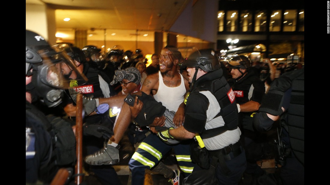 Police officers and protesters carry a man who was shot <a href="http://www.cnn.com/2016/09/21/us/charlotte-police-shooting/" target="_blank">during a second night of protests</a> in Charlotte, North Carolina, on Wednesday, September 21. The shooting victim, 26-year-old Justin Carr, later died.  <a href="http://www.cnn.com/2016/09/21/us/gallery/charlotte-protest/index.html" target="_blank">Violent protests erupted in Charlotte</a> following the death of Keith Lamont Scott, who was shot by police in an apartment complex parking lot. Charlotte-Mecklenburg Police Chief Kerr Putney said Scott exited his car with a gun and that he was shot after he wouldn't drop it. Scott's family said he was unarmed and sitting in his car reading a book.