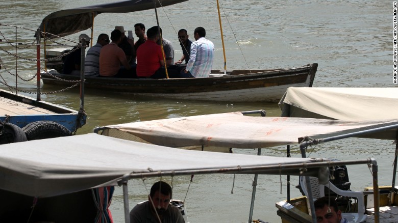Iraqis ride boats in the Tigris River in the capital Baghdad in August