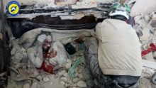 This photo was released by the volunteer group Syria Civil Defense of the bodies of a man, with his knee pulled up near his face, and a child covered in dust after they were killed in the airstrike.