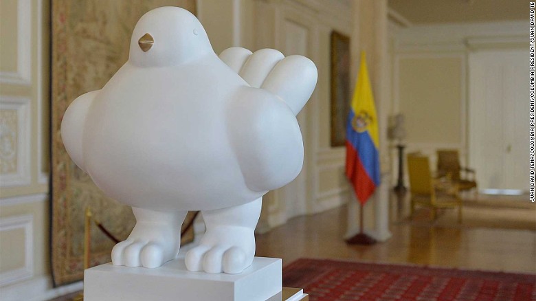 Artist Fernando Botero presented the &quot;The Dove of Peace&quot; to the Colombian president on Saturday to mark the historic deal.