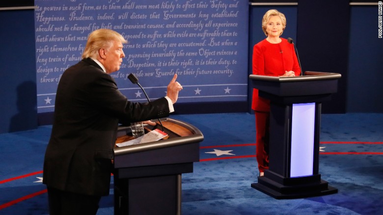 Donald Trump (L) speaks as Hillary Clinton (R) listens during the Presidential Debate at Hofstra University on September 26, 2016 in Hempstead, New York.  