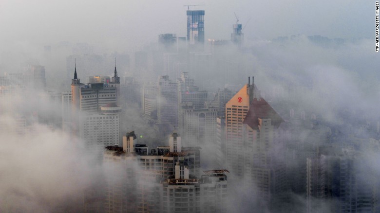 This photo taken on March 29, 2015 shows heavy fog covering buildings in Qingdao, east China&#39;s Shandong province. Falls in Chinese housing prices decelerated in March from the previous month, a survey showed on March 31, after authorities loosened mortgage and tax policies as growth in the world&#39;s second-largest economy slows.   CHINA OUT   AFP PHOTO        (Photo credit should read STR/AFP/Getty Images)