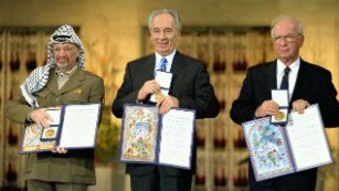 Peres receiving the Nobel Peace Prize in 1994, alongside Yitzhak Rabin and Yasser Arafat.