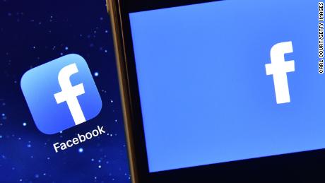 The Facebook app logo is displayed on an iPad next to a picture of the Facebook logo on an iPhone on August 3, 2016 in London, England. 