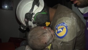 Rescuer weeps after saving Syrian baby