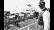 President Saddam Hussein waves to supporters from the balcony of the mayor's office in Mosul on a trip to see how farmers were faring under international sanctions.