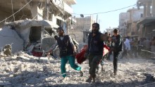 TOPSHOT - Syrian volunteers carry an injured person on a stretcher following Syrian government forces airstrikes on the rebel held neighbourhood of Heluk in Aleppo, on September 30, 2016.
Syrian regime forces advanced in the battleground city of Aleppo, backed by a Russian air campaign that a monitor said has killed more than 3,800 civilians in the past year. / AFP / THAER MOHAMMED        (Photo credit should read THAER MOHAMMED/AFP/Getty Images)
