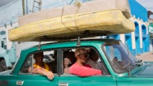 People carry their mattresses to a shelter in Santiago, Cuba, on Sunday.