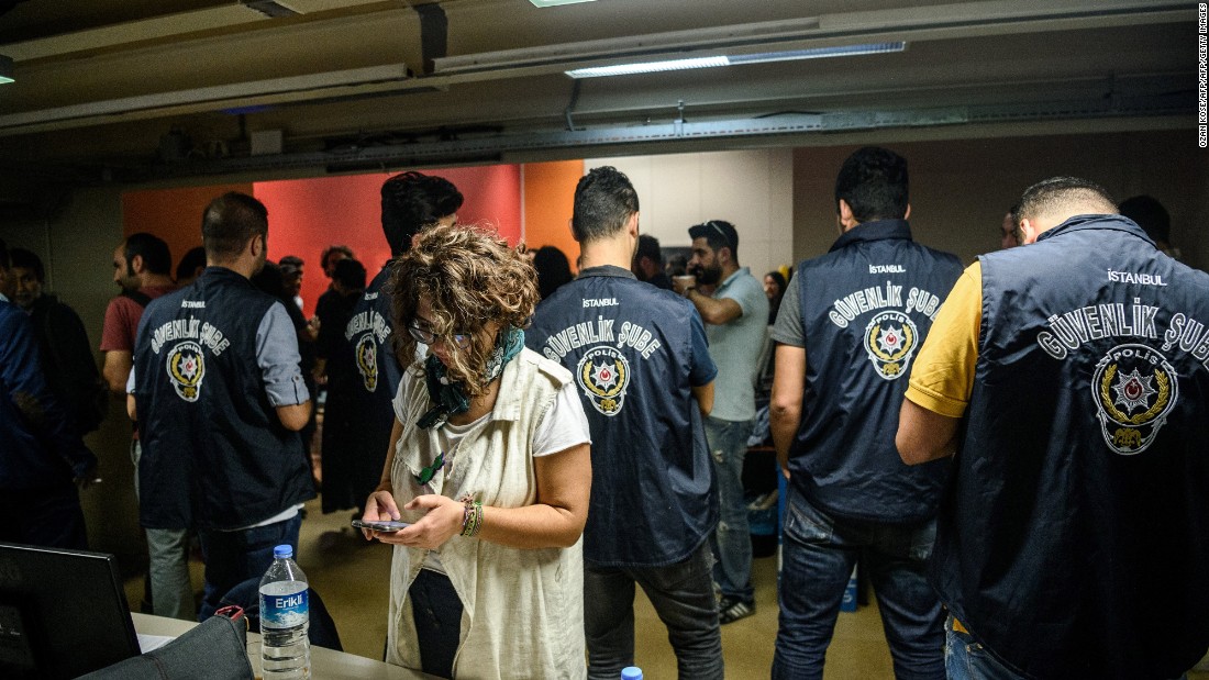Turkish police officers in the offices of IMC TV station during a raid on October 4, 2016 in Istanbul.