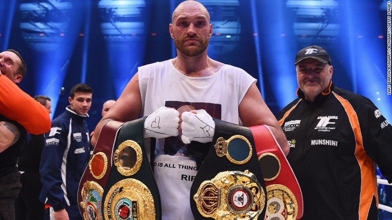 Tyson Fury celebrates with his belts after beating Wladimir Klitschko to become new World Heavyweight Champion after the IBF IBO WBA WBO contest.