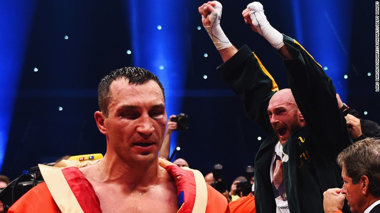 The defeated Klitschko leaves the ring as Fury enjoys his moment of triumph.