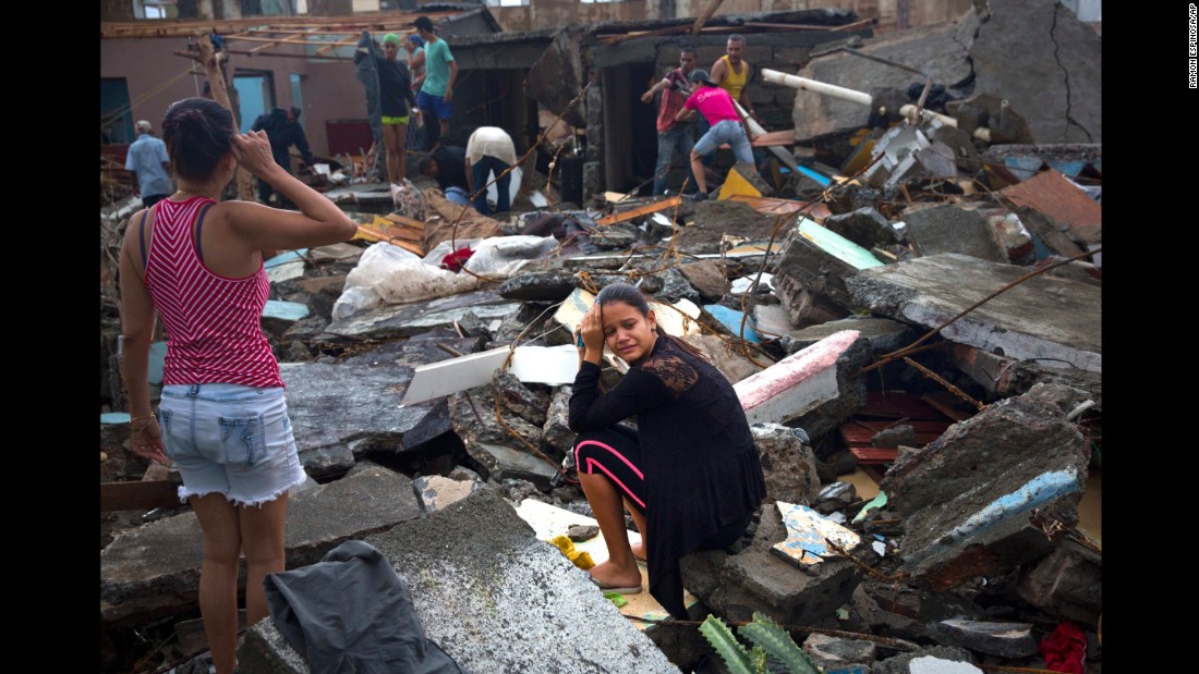 A woman cries amid the rubble of her home in Baracoa.