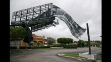 A billboard canvas flaps in the wind after Hurricane Matthew passed North Palm Beach, Florida, on October 7.