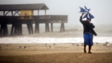 Preston Payne tries to hold his umbrella on Georgia's Tybee Island on October 7.