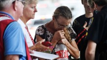 A police officer helps persuade a woman to board a bus and evacuate Savannah, Georgia, on October 7.