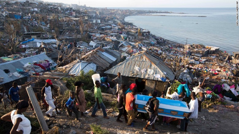 In Jeremie, Haiti, Hurricane Matthew claimed the life of a pregnant woman, whose remains were carried in a coffin by local residents on Friday, October 7, 2016.