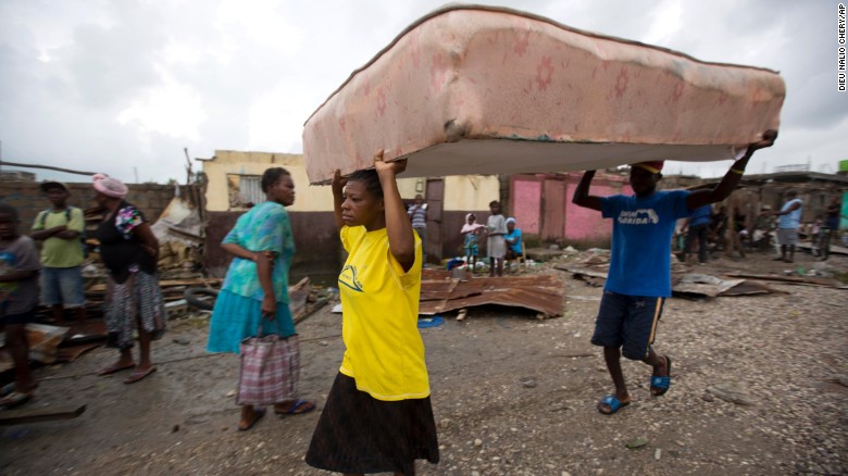 Residents rush to nearby shelters in the aftermath of Hurricane Matthew in Les Cayes, Haiti.