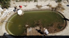 Volunteers clear debris from from a pool at a condominium complex in Jacksonville Beach, Florida, on October 8.