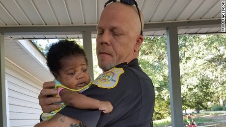 Officer saves baby from choking and becomes her godfather