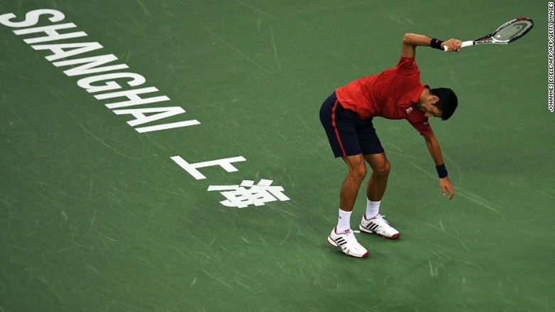 Djokovic smashes his racket after losing the first set.