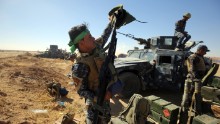 An Iraqi police officer inspects his weapon at the Qayyara military base about 60 kilometers (35 miles) south of Mosul on Sunday, October 16. If Iraqi forces regain control of Mosul, it will be the latest in a string of victories, including the recapture of the Qayyara oil refinery and airbase.