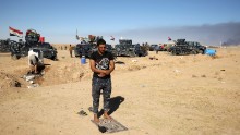 A Sunni Iraqi police officer prays at the Qayyara airbase on October 16.