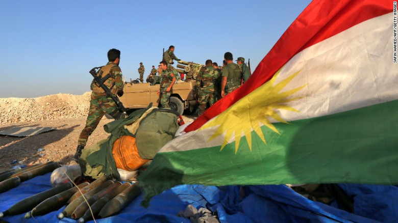 Iraqi Kurdish Peshmerga fighters prepare to fire a rocket launcher near the town of Bashiqa, about 15 miles northeast of Mosul, on October 20, 2016.